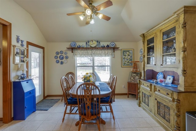 tiled dining room featuring ceiling fan and vaulted ceiling