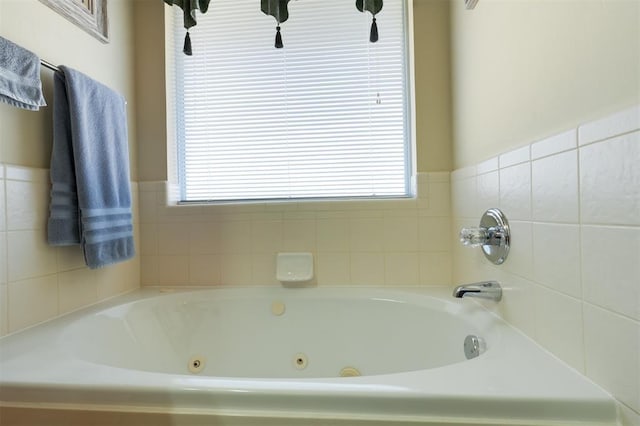 bathroom featuring plenty of natural light and a washtub