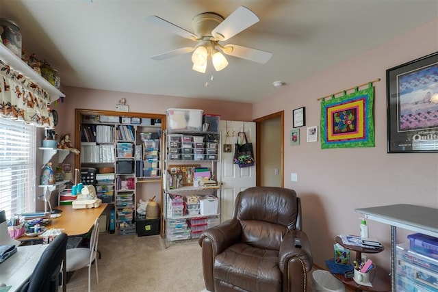 living area featuring carpet floors and ceiling fan