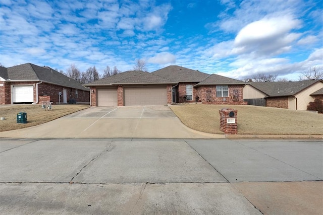 view of front of property with a garage and a front yard