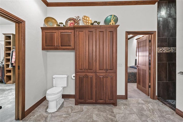 bathroom with crown molding and toilet