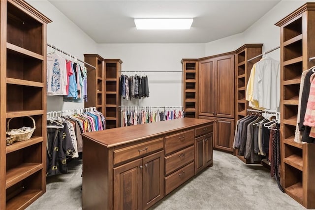 walk in closet featuring light carpet