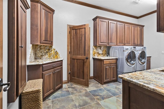 laundry area featuring cabinets, crown molding, and washer and dryer