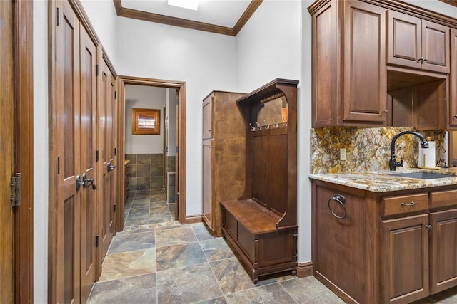 mudroom featuring crown molding and sink