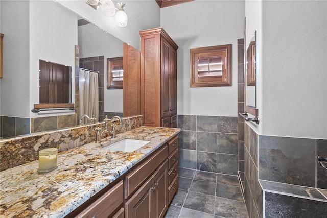 bathroom with vanity and tile walls