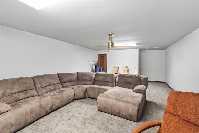 carpeted living room with ceiling fan