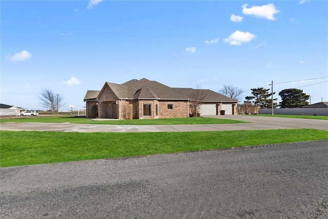 view of front of property with a garage and a front yard