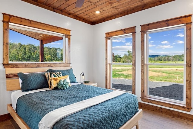 bedroom featuring wood ceiling, ceiling fan, access to exterior, and hardwood / wood-style floors