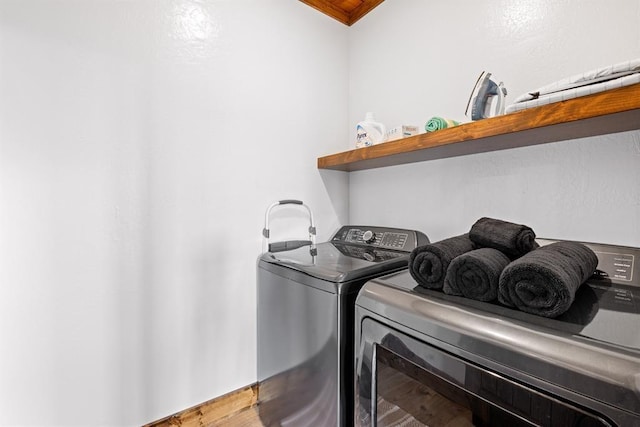 washroom with hardwood / wood-style floors and washer and clothes dryer