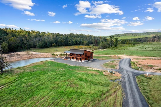 surrounding community with an outdoor structure and a water view