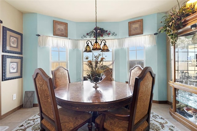 dining room with light tile patterned flooring, plenty of natural light, and baseboards