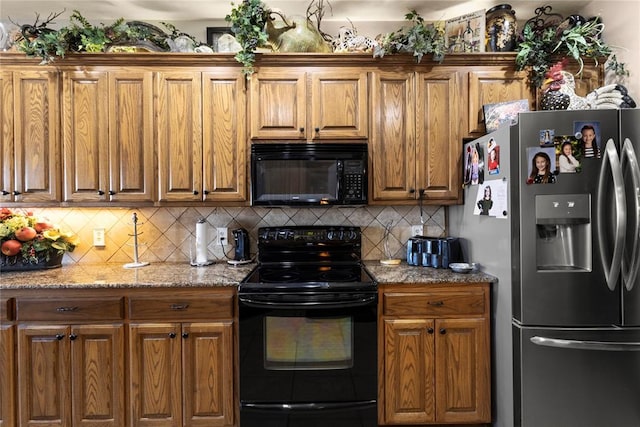 kitchen with black appliances, tasteful backsplash, and brown cabinets