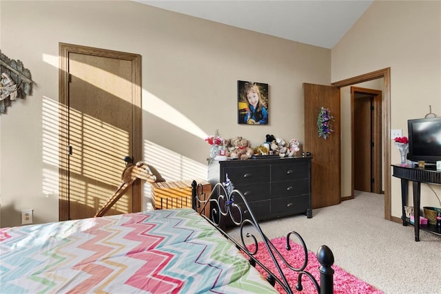 bedroom with lofted ceiling and carpet floors