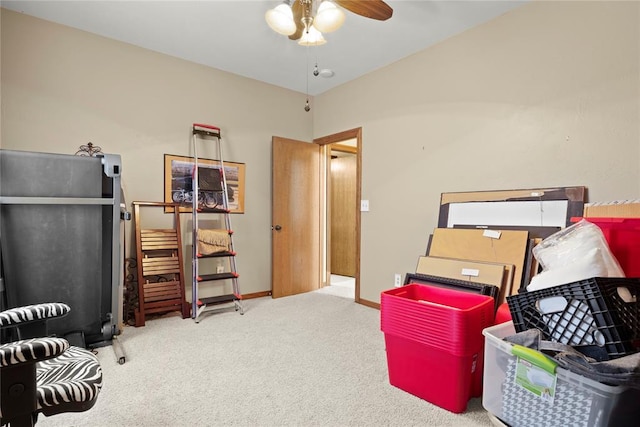 interior space featuring a ceiling fan, carpet, and baseboards