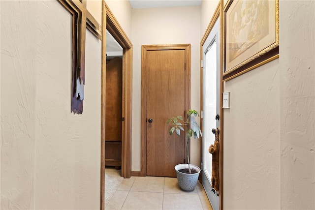 corridor featuring light tile patterned flooring