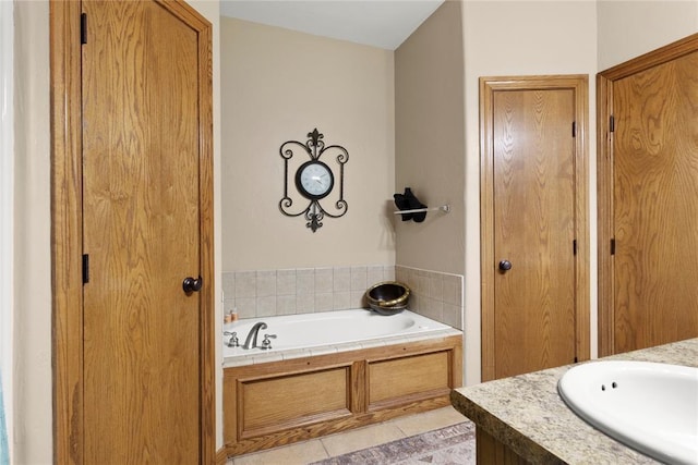 bathroom with tile patterned floors, vanity, and a bath