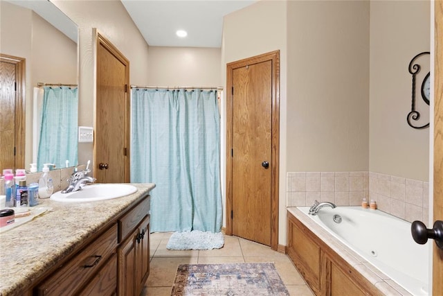 full bathroom featuring a garden tub, vanity, and tile patterned floors