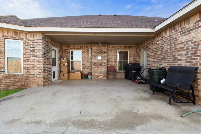 view of patio / terrace featuring driveway and grilling area