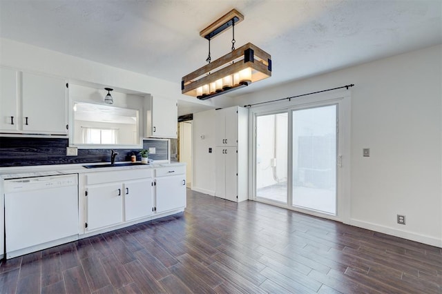 kitchen featuring sink, white cabinets, dark hardwood / wood-style flooring, decorative backsplash, and white dishwasher