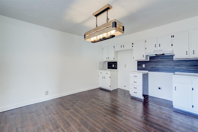 kitchen with white cabinetry, dark hardwood / wood-style flooring, and decorative backsplash