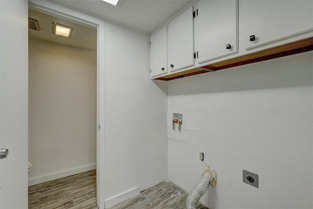 laundry area featuring cabinets, hookup for a washing machine, light hardwood / wood-style floors, and hookup for an electric dryer