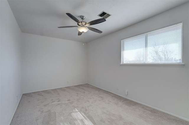 carpeted empty room featuring ceiling fan