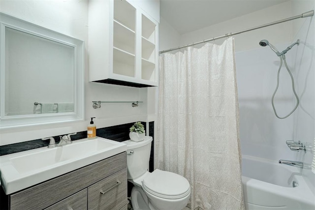 full bathroom with vanity, shower / bath combo, and toilet