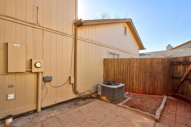 view of property exterior featuring central AC unit and a patio