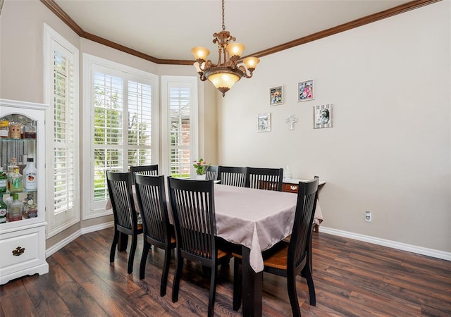 dining area featuring crown molding, dark wood-type flooring, and an inviting chandelier