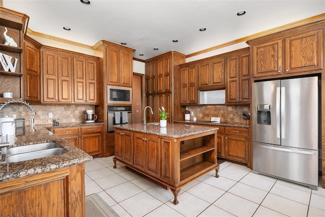 kitchen with stone counters, light tile patterned flooring, sink, a kitchen island with sink, and black appliances