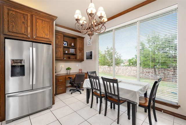 tiled dining area featuring ornamental molding, a wealth of natural light, and built in desk