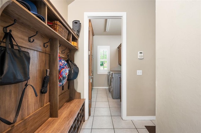 mudroom featuring light tile patterned floors and independent washer and dryer