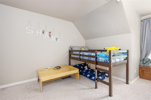 bedroom with lofted ceiling and light colored carpet