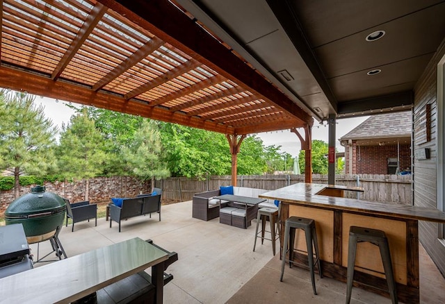 view of patio / terrace featuring a bar, grilling area, an outdoor hangout area, and a pergola