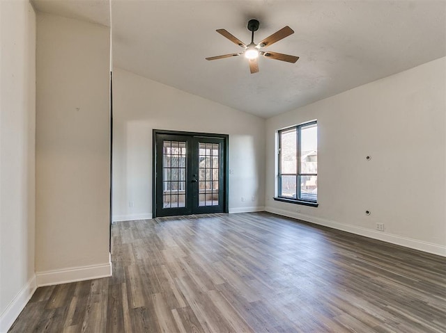 spare room featuring ceiling fan, wood finished floors, baseboards, vaulted ceiling, and french doors