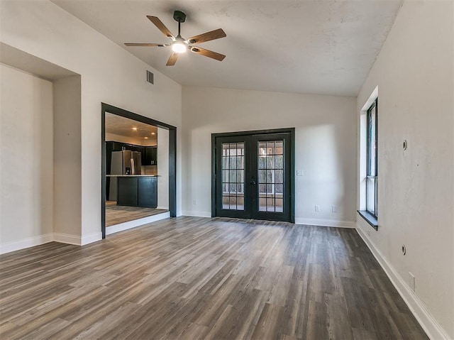 empty room featuring lofted ceiling, visible vents, wood finished floors, and french doors