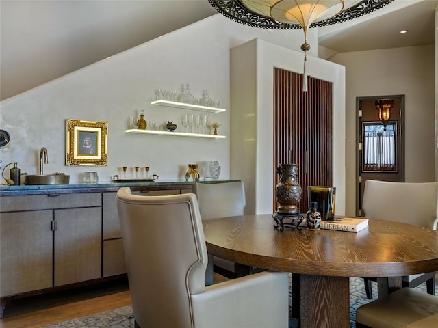 dining space featuring hardwood / wood-style flooring and wet bar