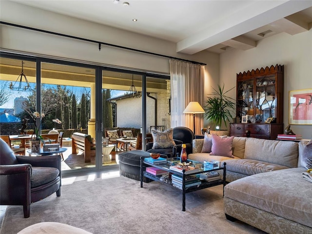 carpeted living room with beam ceiling