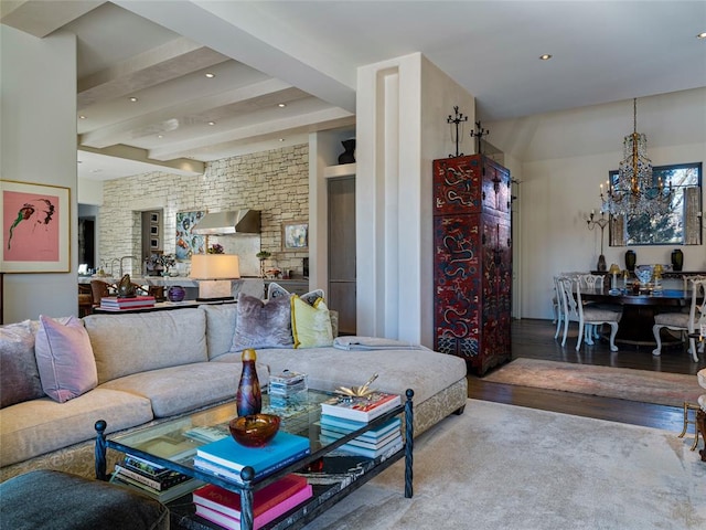 living room featuring an inviting chandelier, hardwood / wood-style floors, and beam ceiling