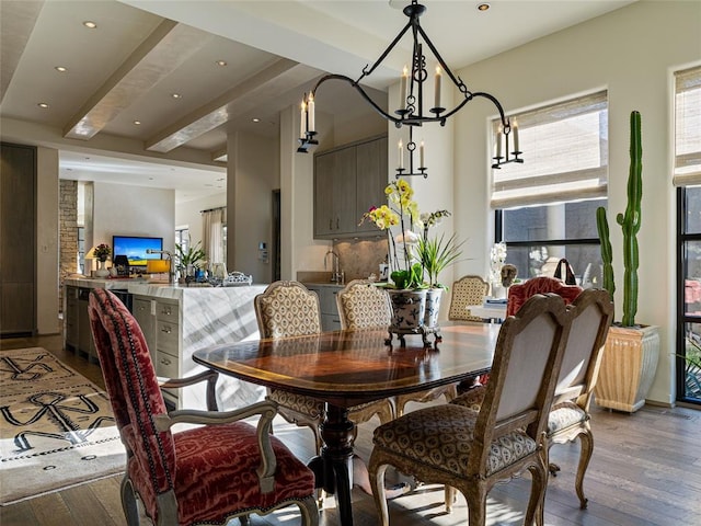 dining area with beam ceiling and light hardwood / wood-style floors