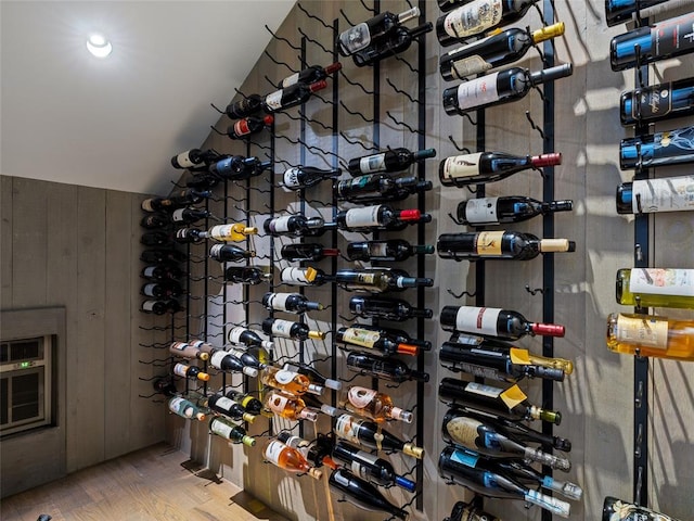 wine area featuring vaulted ceiling and hardwood / wood-style floors