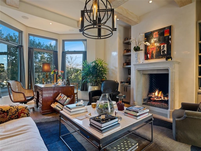 living room with a chandelier, dark hardwood / wood-style flooring, and built in shelves