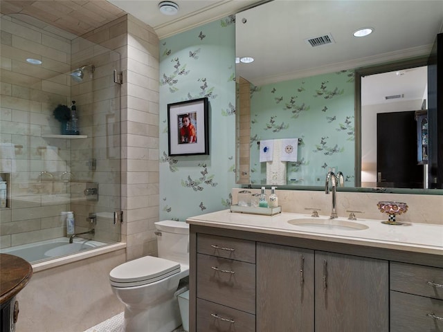 full bathroom featuring vanity, ornamental molding, shower / bath combination with glass door, and toilet