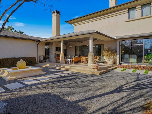 exterior space featuring a fireplace and a patio