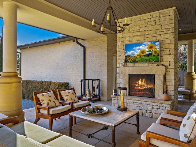 view of patio with an outdoor living space with a fireplace