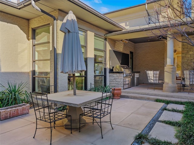 view of patio / terrace with exterior bar, area for grilling, and grilling area