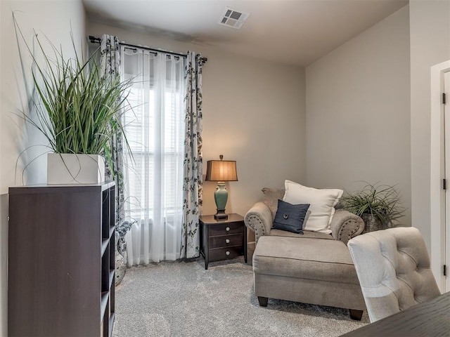 living area featuring light carpet