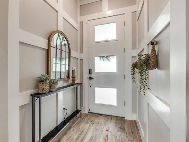 entryway featuring light hardwood / wood-style flooring and a high ceiling