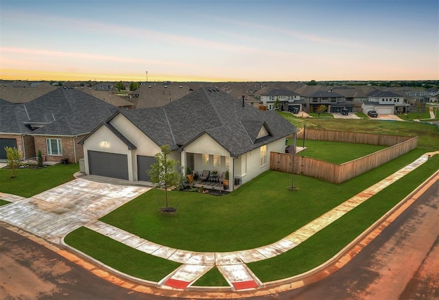 view of front of home with a garage and a yard