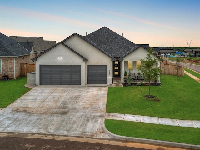 view of front of home featuring a garage and a lawn